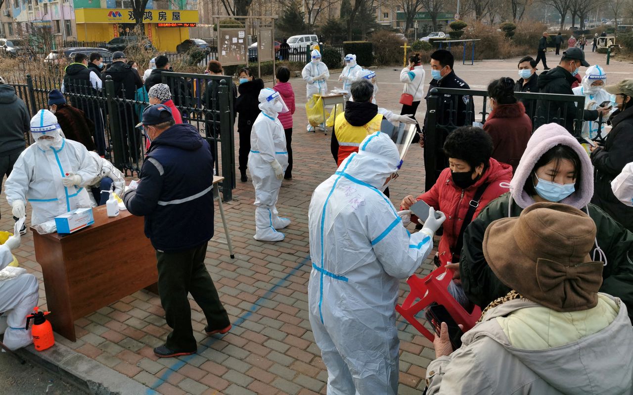 FILE PHOTO: Residents line up at a nucleic acid testing site during a mass testing for the coronavirus disease (COVID-19), at a residential compound in Dalian, Liaoning province, China March 16, 2022. China Daily via REUTERS
