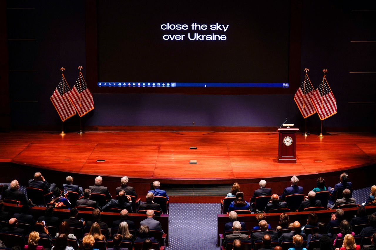 The words "close the sky over Ukraine" are displayed on the screen as Ukrainian President Volodymyr Zelenskiy speaks to senators and members of the House of Representatives gathered in the Capitol Visitor Center Congressional Auditorium, at the U.S. Capitol in Washington, U.S., March 16, 2022. J. Scott Applewhite/Pool via REUTERS