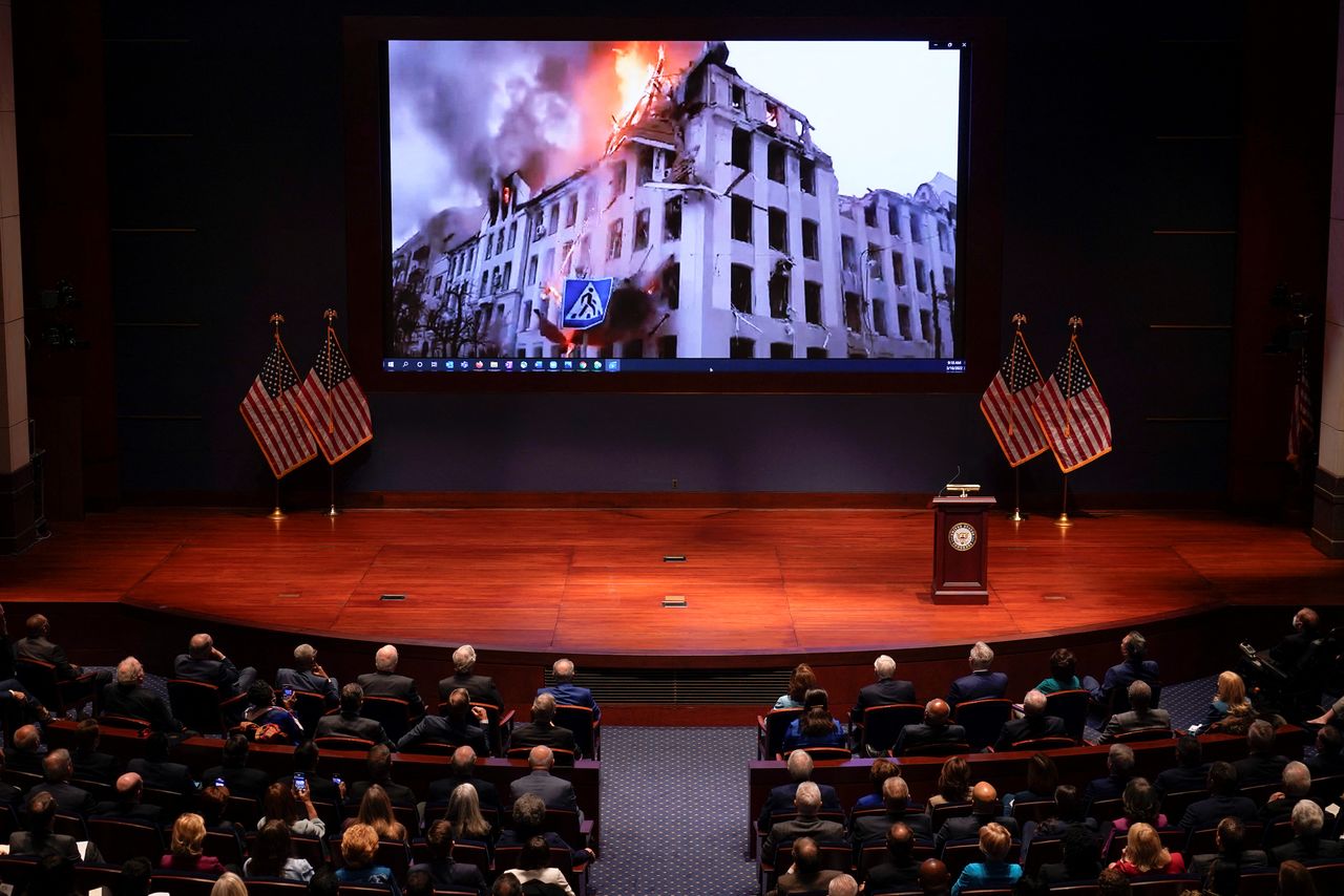 Footage from Ukraine is displayed as Ukrainian President Volodymyr Zelenskyy speaks to senators and members of the House of Representatives gathered in the Capitol Visitor Center Congressional Auditorium, at the U.S. Capitol in Washington, U.S., March 16, 2022. J. Scott Applewhite/Pool via REUTERS