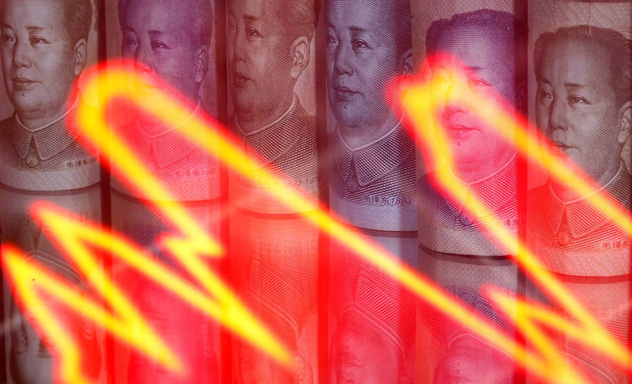 FILE PHOTO: Chinese Yuan banknotes are seen behind illuminated stock graph in this illustration taken February 10, 2020. REUTERS/Dado Ruvic/Illustration