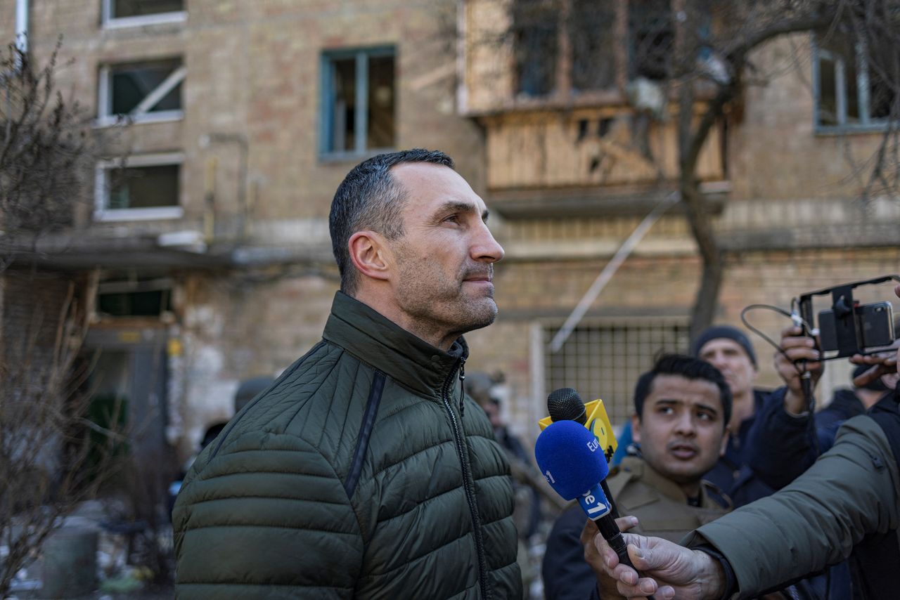 Former world boxing heavyweight champion Wladimir Klitschko stands at a residential district that was damaged by shelling, as Russia