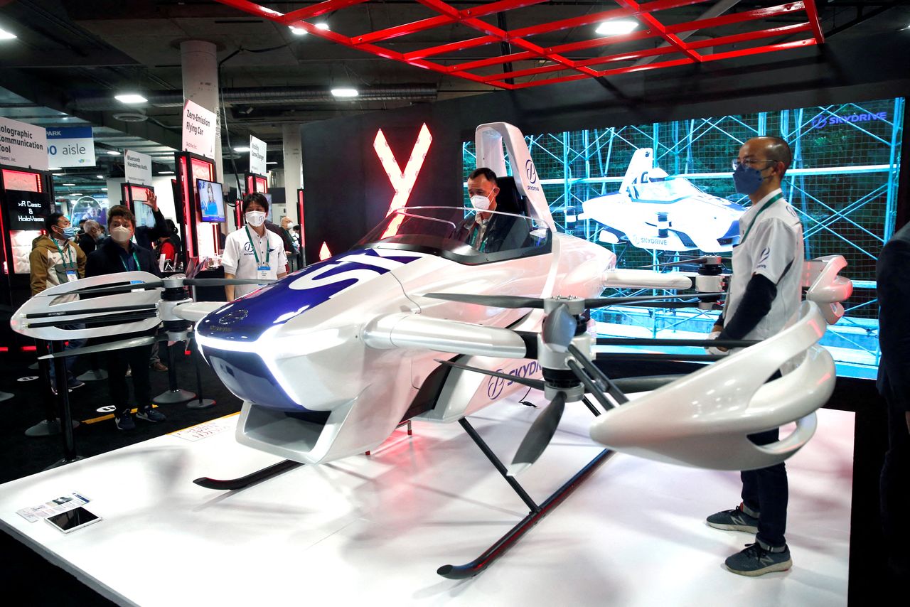 FILE PHOTO: An attendee checks out a zero-emissions SkyDrive flying car during CES 2022 in Las Vegas, Nevada, U.S. January 6, 2022. REUTERS/Steve Marcus/
