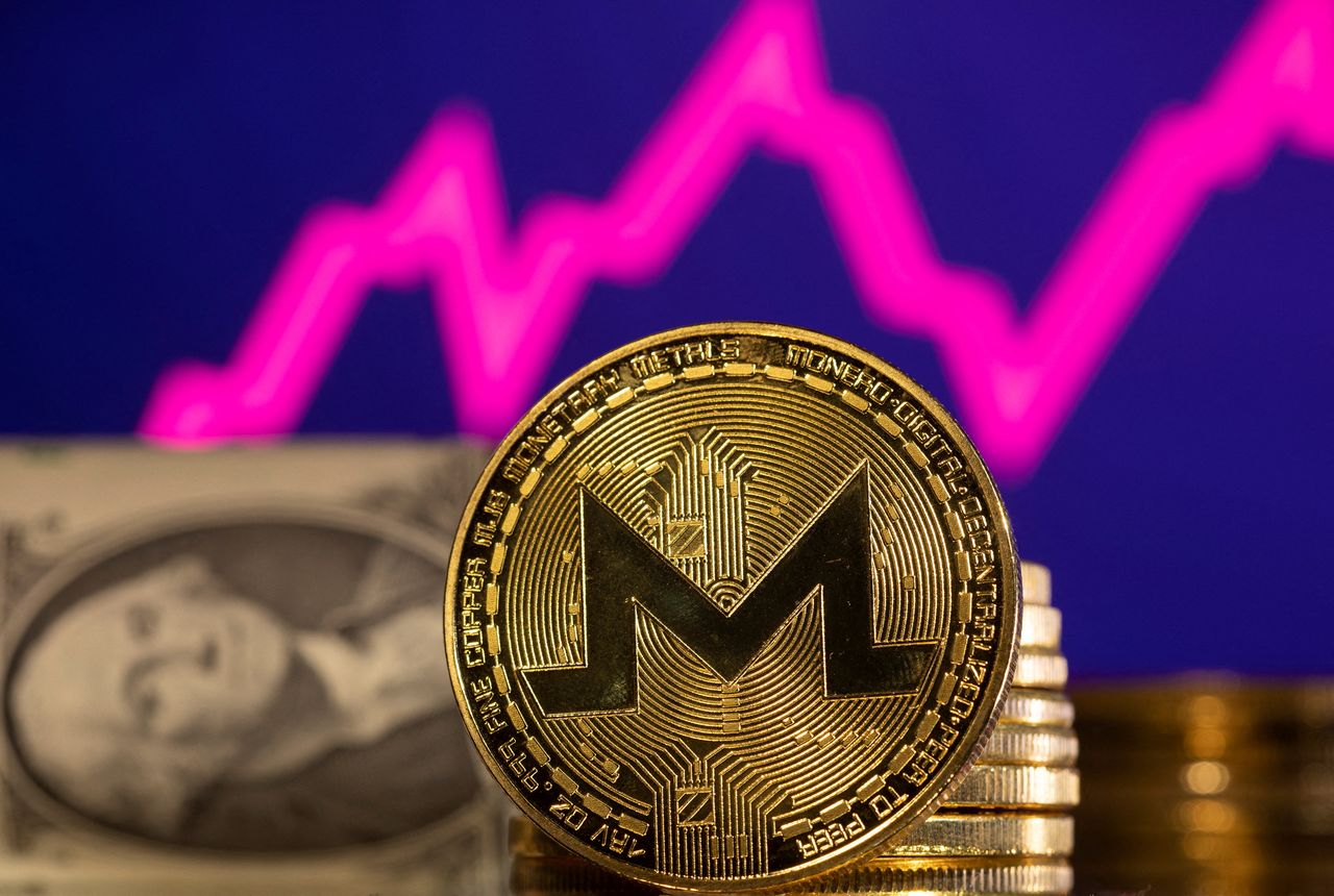 FILE PHOTO: A representations of cryptocurrency  Monero is seen in front of a stock graph and U.S. dollar in this illustration taken, January 24, 2022. REUTERS/Dado Ruvic/Illustration