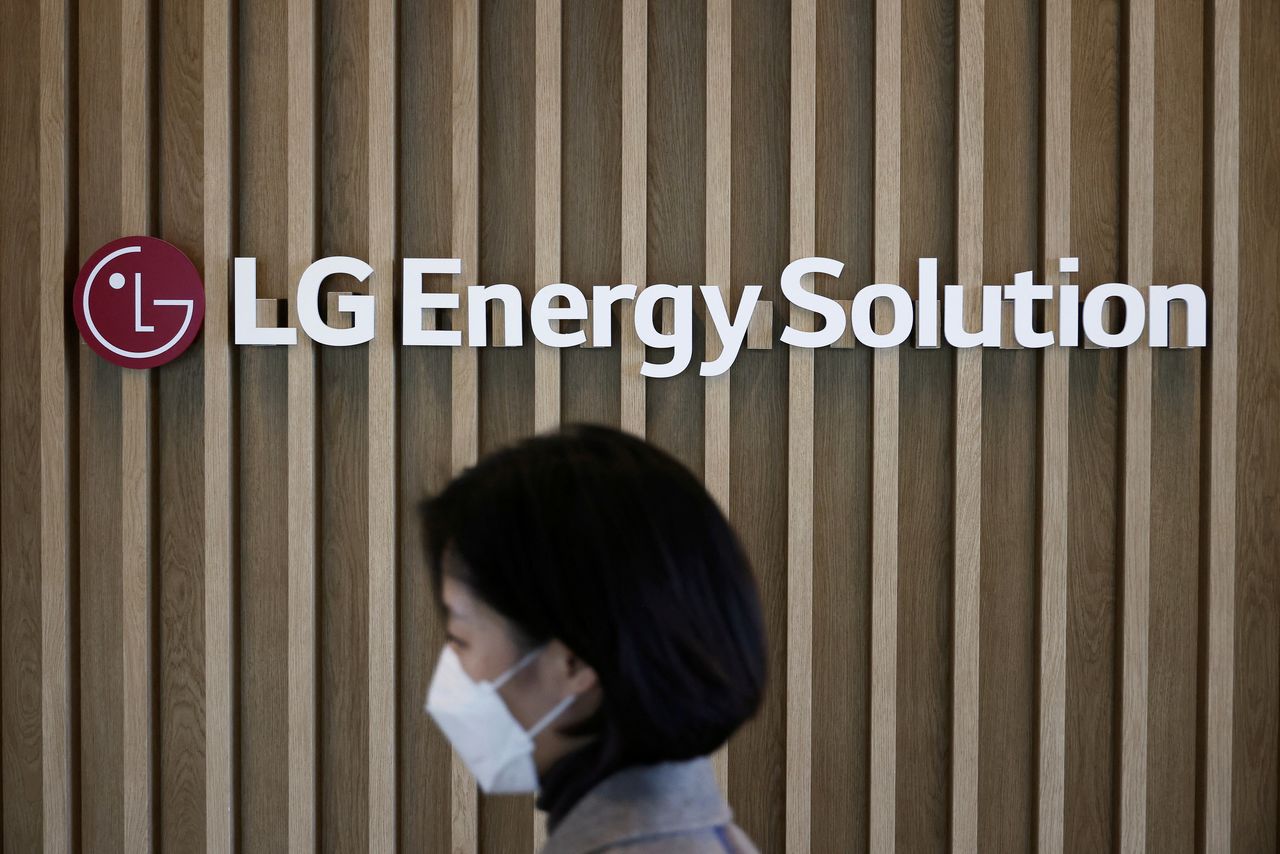 FILE PHOTO: An employee walks past the logo of LG Energy Solution at its office building in Seoul, South Korea, November 23, 2021.  REUTERS/Kim Hong-Ji/File Photo