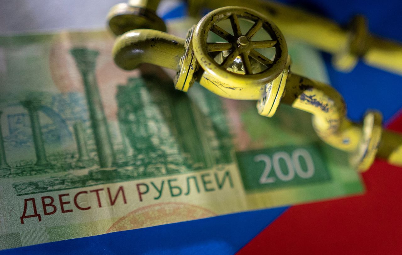 A model of the natural gas pipeline is placed on Russian Rouble banknote and a flag in this illustration taken, March 23, 2022. REUTERS/Dado Ruvic/Illustration