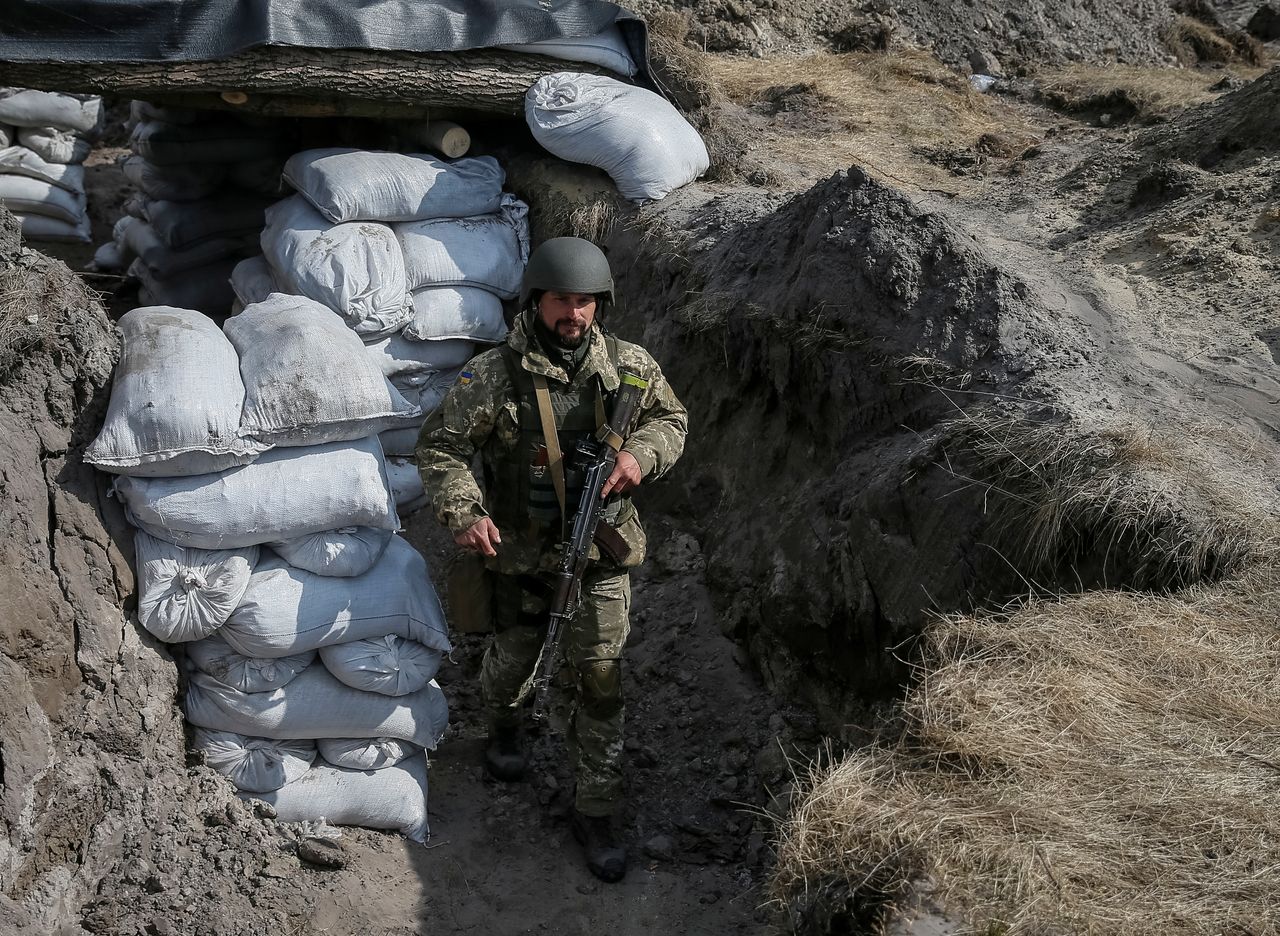 A Ukrainian service member stands at a position on the front line in the north Kyiv region, Ukraine March 24, 2022. REUTERS/Gleb Garanich