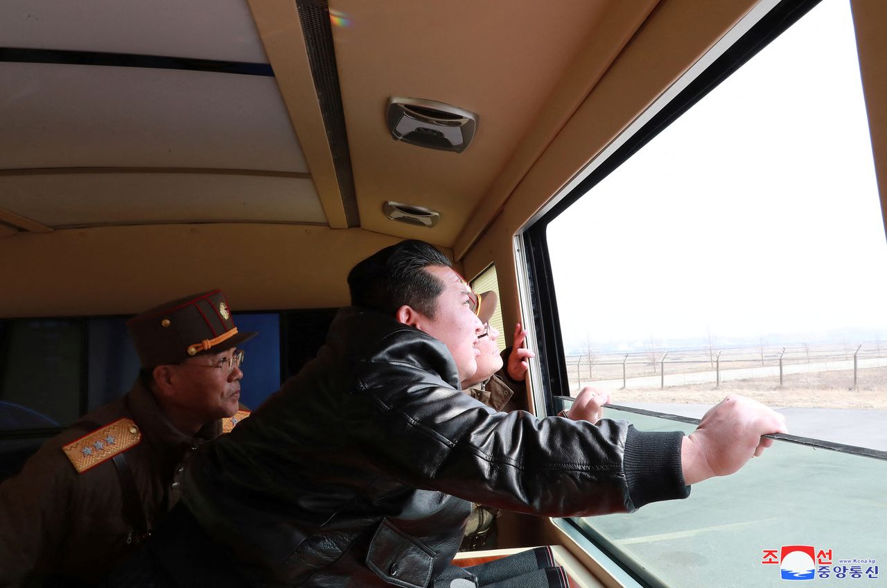 North Korean leader Kim Jong Un looks through a window during the test firing of what state media report is a "new type" of intercontinental ballistic missile (ICBM) in this undated photo released on March 24, 2022 by North Korea
