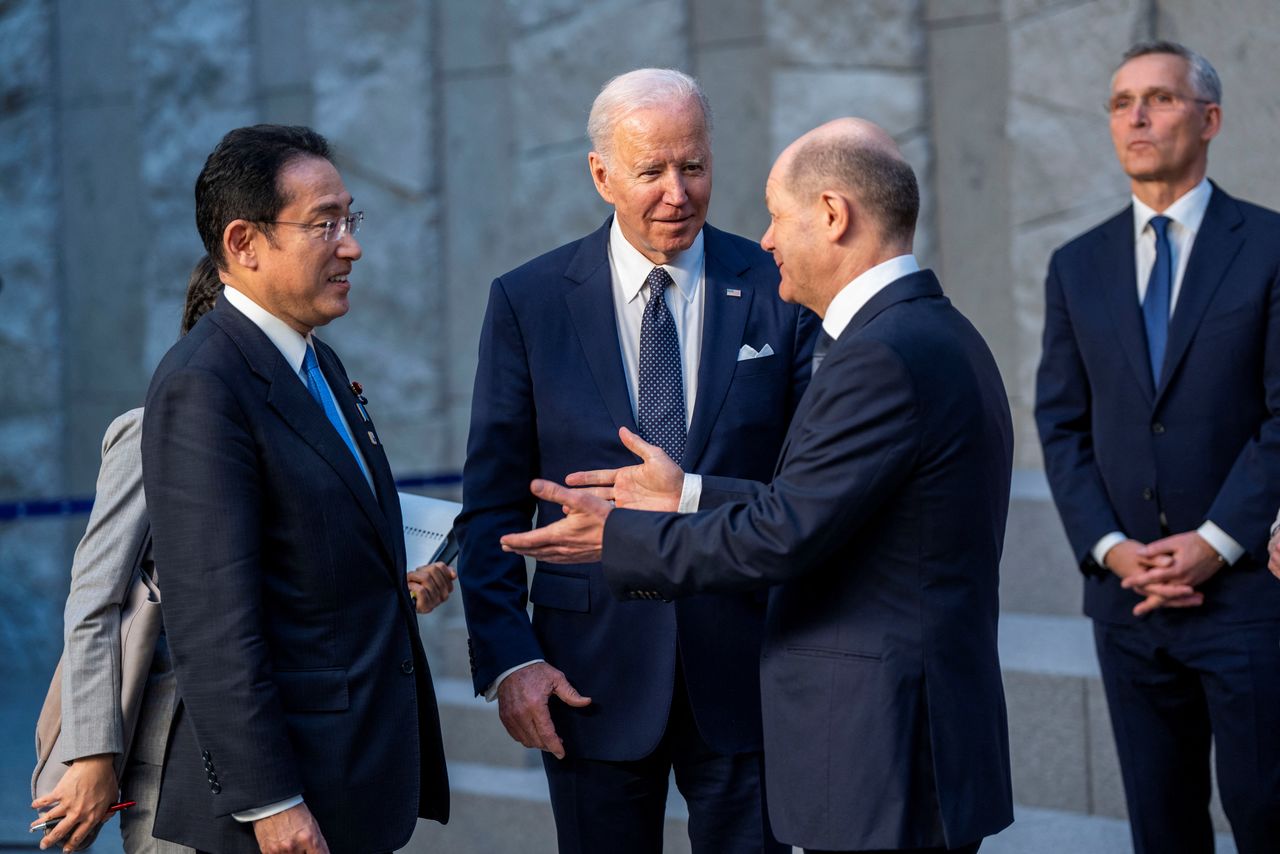 FILE PHOTO: U.S. President Joe Biden talks with German Chancellor Olaf Scholz and Japanese Prime Minister Fumio Kishida during a family photo with G7 leaders at NATO  Headquarters in Brussels, Belgium, March 24, 2022. Doug Mills/Pool via REUTERS