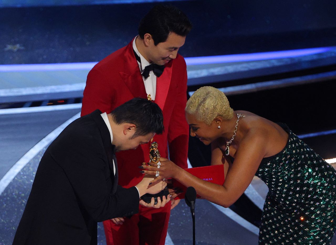 Director Ryusuke Hamaguchi accepts the Oscar for Best International Feature Film for "Drive My Car" of Japan from presenters Tiffany Haddish and Simu Liu at the 94th Academy Awards in Hollywood, Los Angeles, California, U.S., March 27, 2022. REUTERS/Brian Snyder