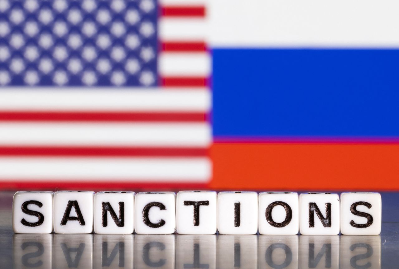 FILE PHOTO: Plastic letters arranged to read "Sanctions" are placed in front the flag colors of U.S. and Russia in this illustration taken February 28, 2022. REUTERS/Dado Ruvic/Illustration
