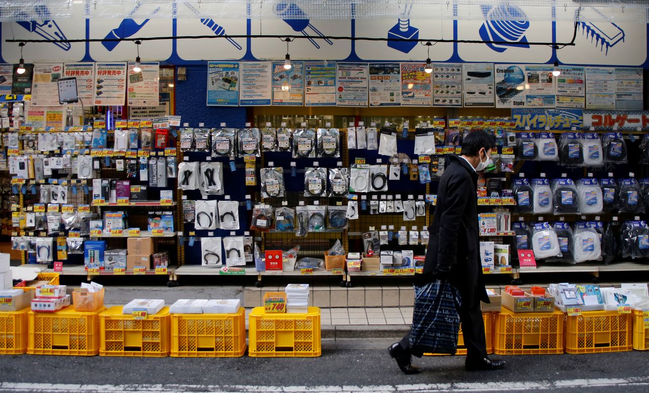 FILE PHOTO: A man walks in front of an electronics store in Tokyo, Japan, January 10, 2017. Picture taken January 10, 2017.  REUTERS/Toru Hanai