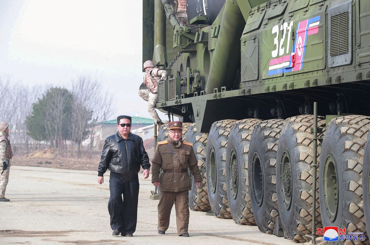 FILE PHOTO: North Korean leader Kim Jong Un walks next to what state media reports is the "Hwasong-17" intercontinental ballistic missile (ICBM) on its launch vehicle in this undated photo released on March 25, 2022 by North Korea