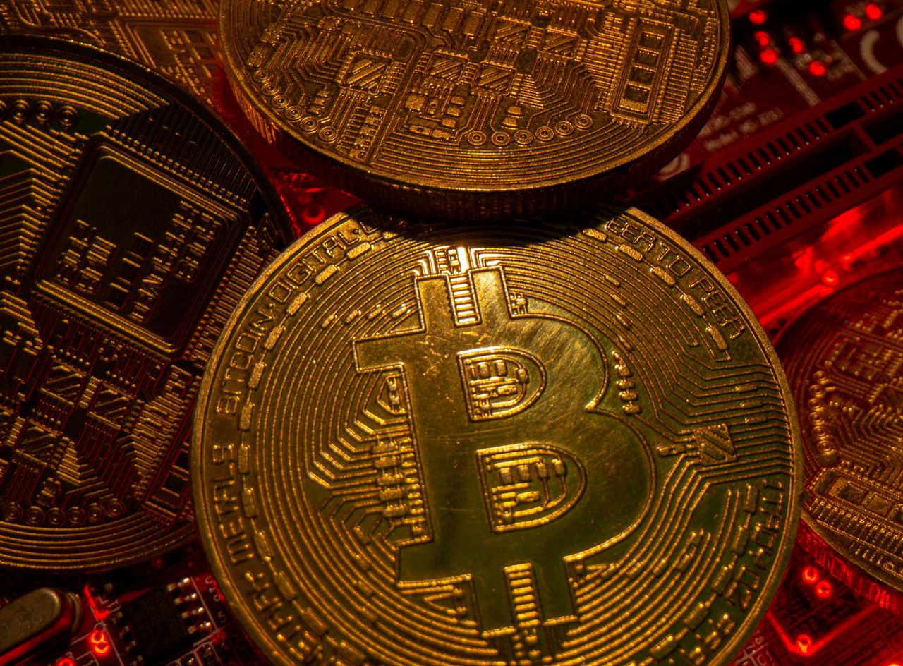 FILE PHOTO: Representations of the virtual currency Bitcoin stand on a motherboard in this picture illustration taken May 20, 2021. REUTERS/Dado Ruvic/