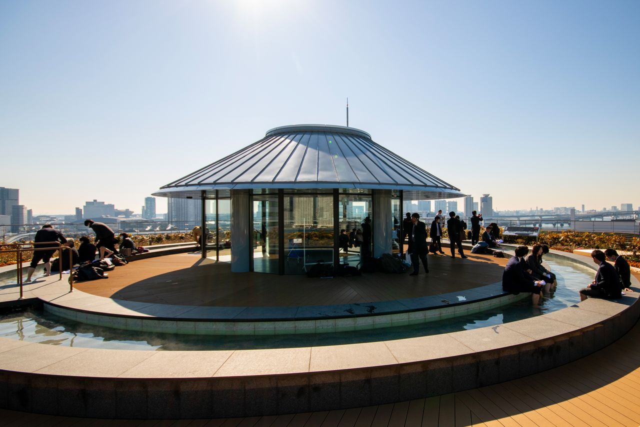 The 360-degree panoramic view at Toyosu Man’yō Club’s rooftop footbath garden offers views of such Tokyo landmarks as the Rainbow Bridge, Toranomon Hills, and Tokyo Tower. (© Nippon.com)