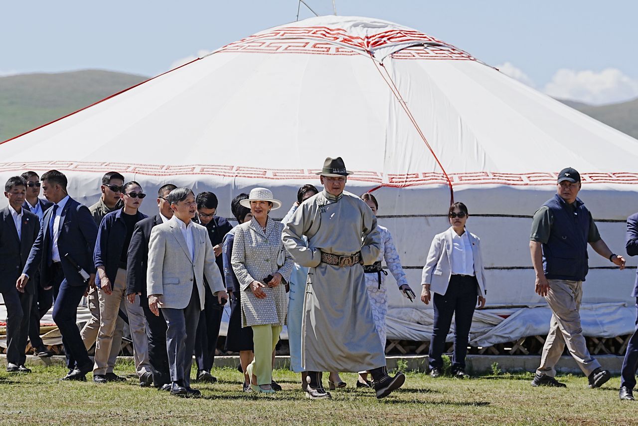 Emperor Naruhito, Empress Masako, and Mongolian President Ukhnaa Khurelsukh on their way to watch the horse race event at the Naadam sports festival on July 12, 2025. (© Jiji)