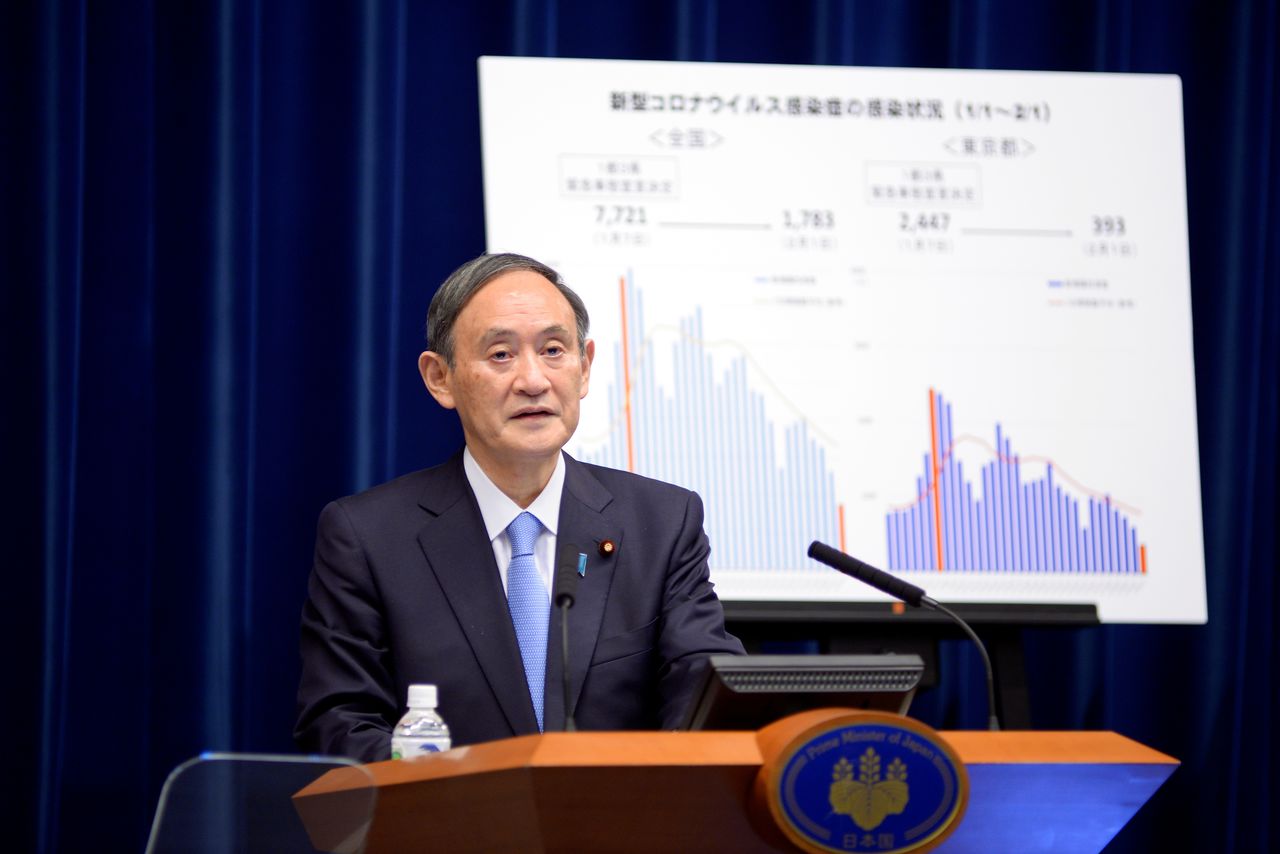 FILE PHOTO: Japan's Prime Minister Yoshihide Suga addresses a news conference on the coronavirus disease (COVID-19) situation at the prime minister's official residence in Tokyo, Japan February 2, 2021. David Mareuil/Pool via REUTERS
