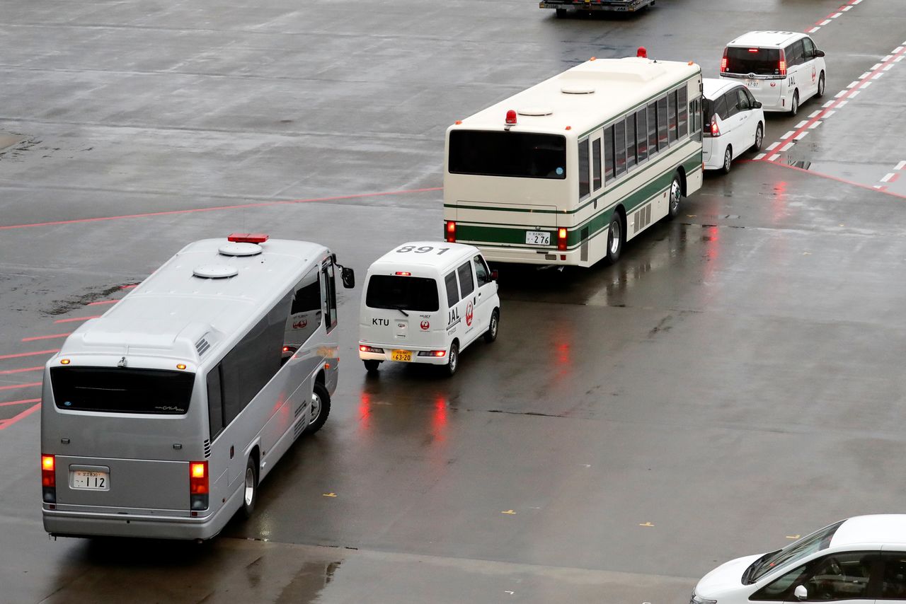 Two buses, believed to carry U.S. citizens Michael Taylor and his son Peter Taylor, who are suspected of helping former Nissan Motor Chairman Carlos Ghosn to escape to Lebanon, leave Narita airport, following Taylors' extradition to Japanese prosecutors, in Chiba, Japan, March 2, 2021. REUTERS/Kim Kyung-Hoon