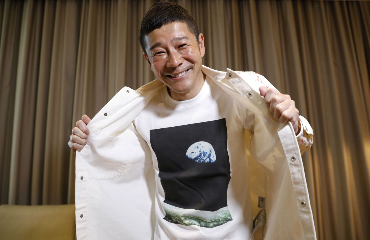 Japanese billionaire Yusaku Maezawa poses with his T-shirt bearing an image of Earth during an interview with Reuters in Tokyo, Japan, March 3, 2021. REUTERS/Kim Kyung-Hoon