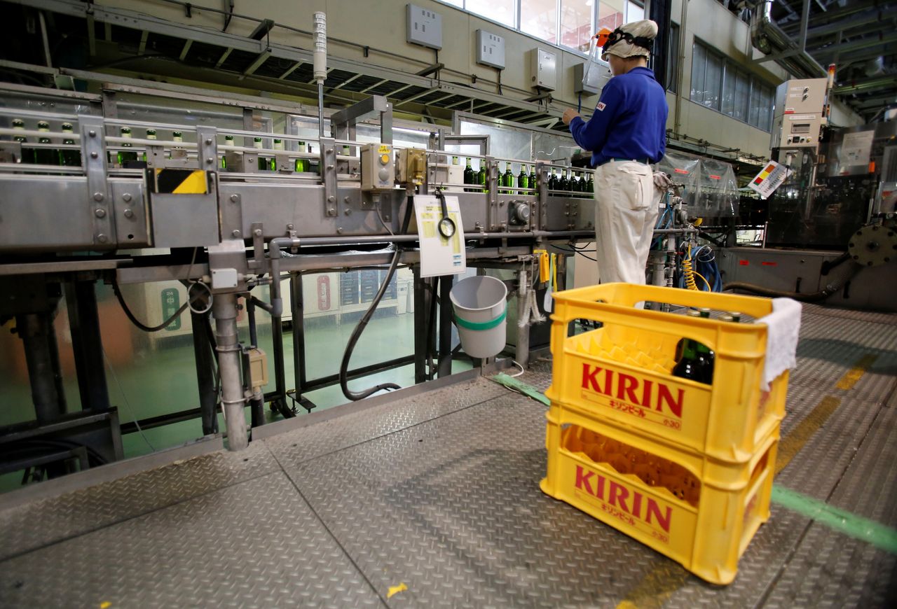 FILE PHOTO: An employee works at a beer production line at Japanese brewer Kirin Holdings' factory in Toride, Ibaraki Prefecture, Japan July 14, 2017. REUTERS/Kim Kyung-Noon