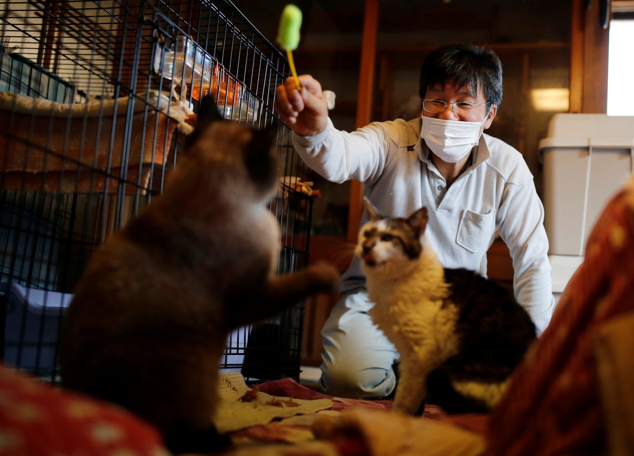 Sakae Kato eats instant noodles for dinner at his home in a restricted zone in Namie, Fukushima Prefecture, Japan, February 20, 2021. Kato looks after 41 cats in his home and another empty building on his property. A decade ago, he stayed behind to rescue cats abandoned by neighbours who fled the radiation clouds belching from the nearby Fukushima nuclear plant. He won't leave. I want to make sure I am here to take care of the last one,