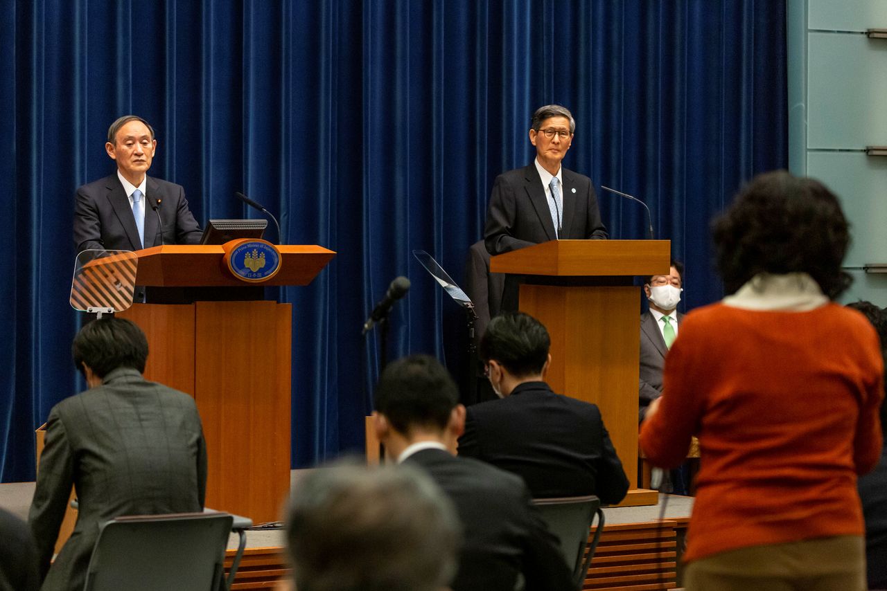 Japanese Prime Minister Yoshihide Suga holds a news conference with President of the Japan Community Healthcare Organization Shigeru Omi in Tokyo, Japan March 5, 2021. Yuichi Yamazaki/Pool via REUTERS