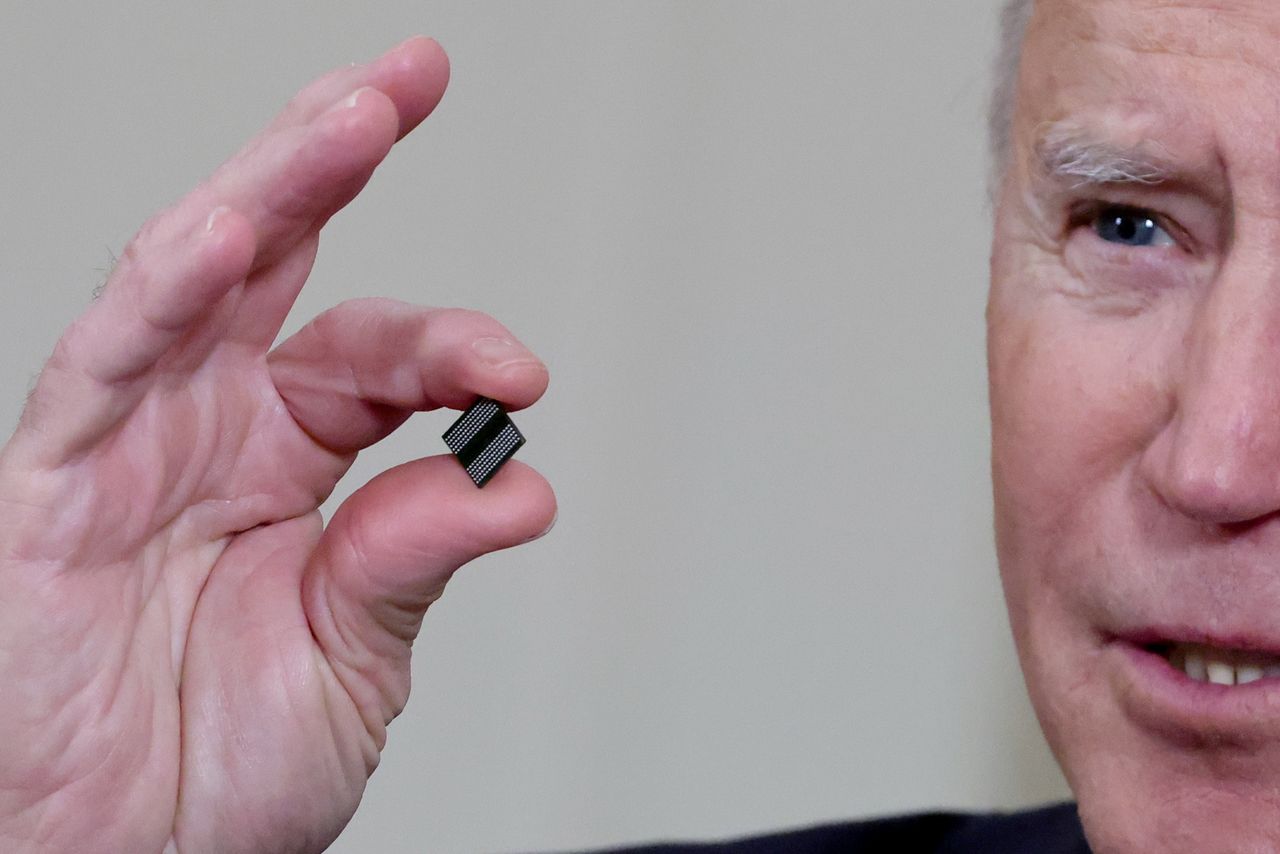 FILE PHOTO: U.S. President Joe Biden holds a semiconductor chip as he speaks prior to signing an executive order, aimed at addressing a global semiconductor chip shortage, in the State Dining Room at the White House in Washington, U.S., February 24, 2021. REUTERS/Jonathan Ernst/File Photo