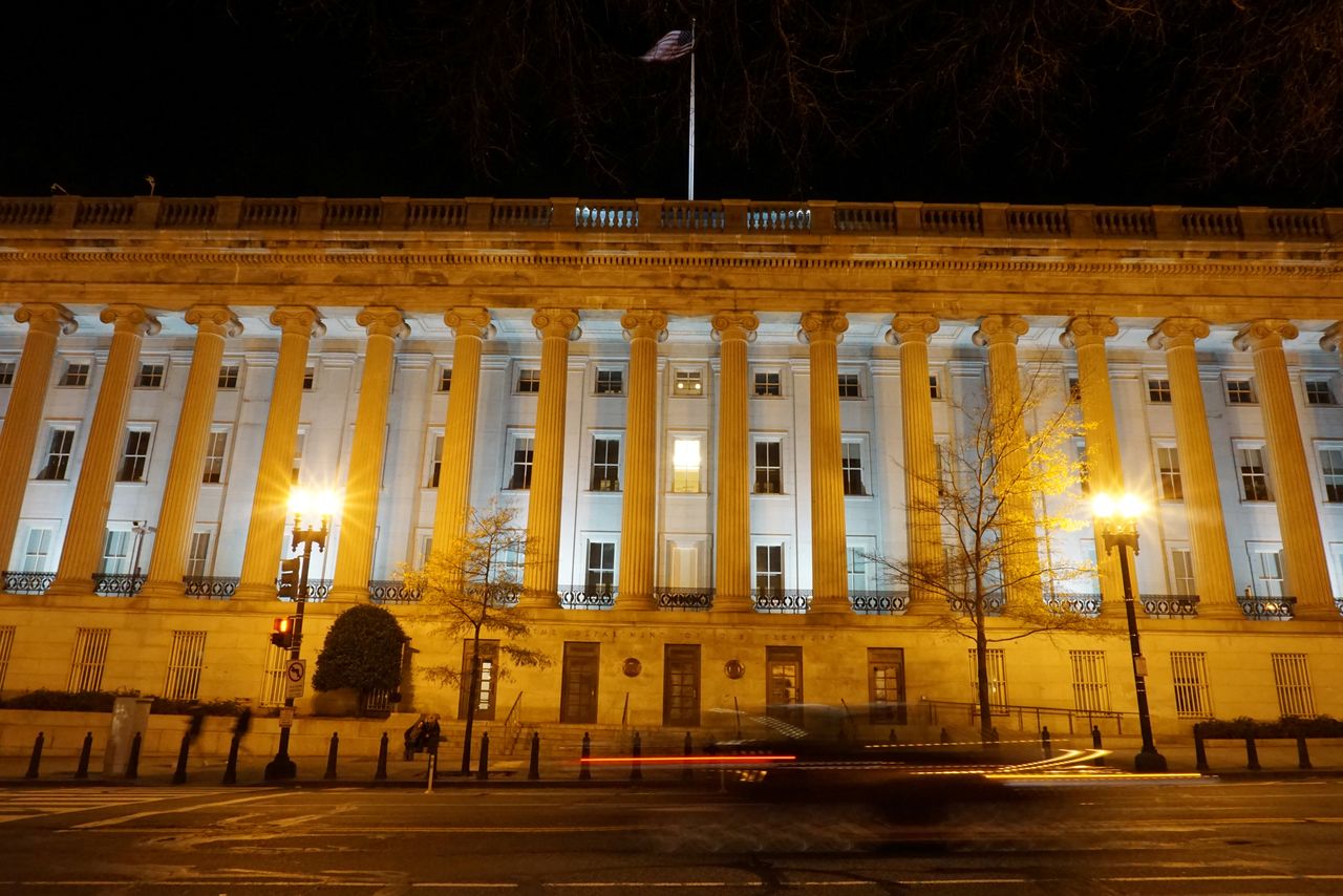 FILE PHOTO: A vehicle drives past the U.S. Treasury Department in Washington, D.C., U.S. December 13, 2020. Picture taken with a long exposure. REUTERS/Raphael Satter