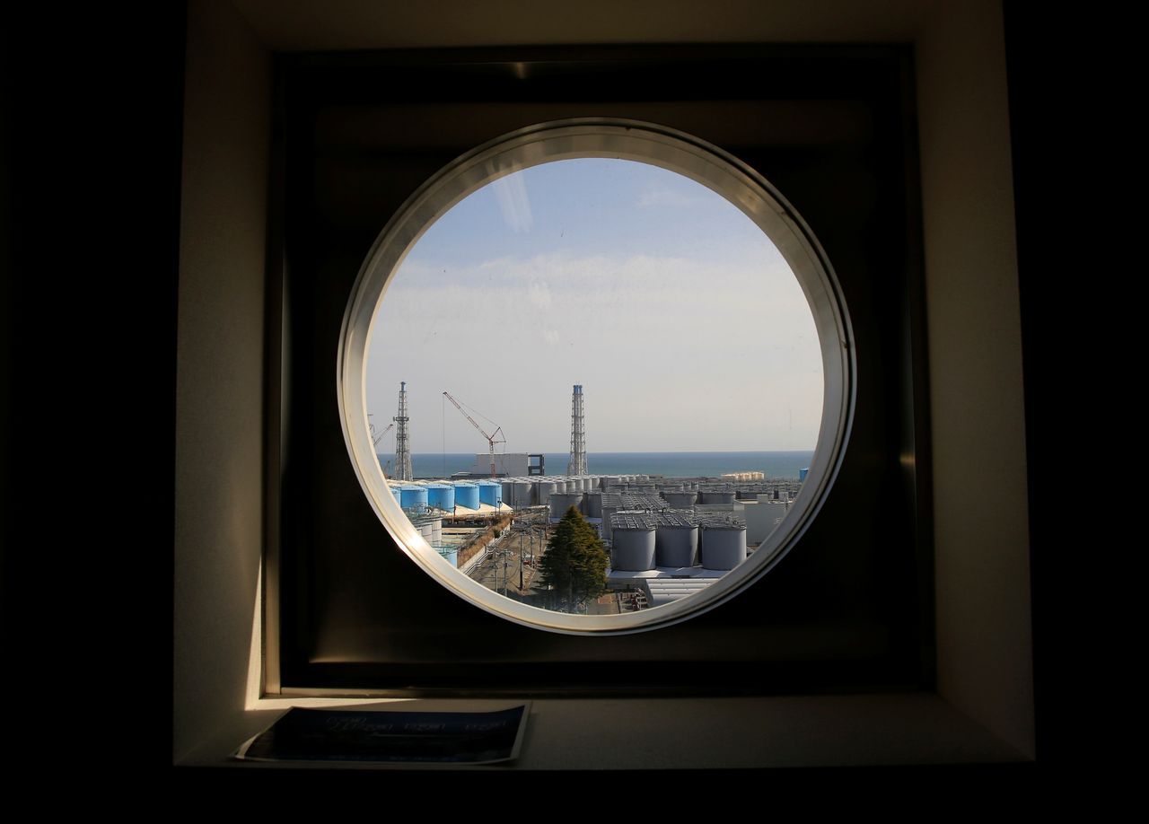 The storage tanks for treated water are seen through a window at the tsunami-crippled Fukushima Daiichi nuclear power plant in Okuma town, Fukushima prefecture, Japan March 1, 2021. Picture taken March 1, 2021. REUTERS/Sakura Murakami