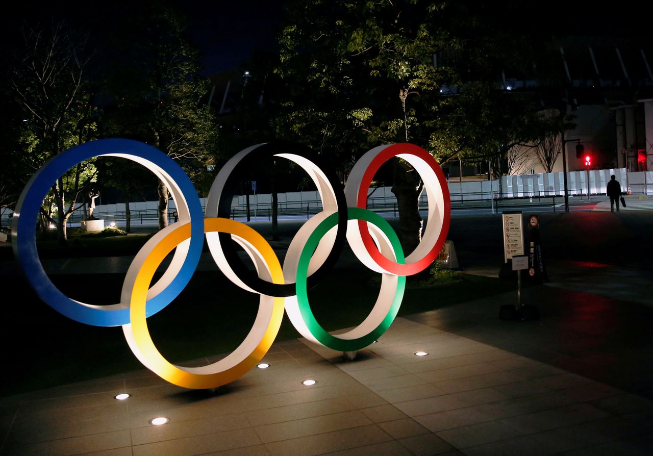 FILE PHOTO: The Olympic rings are illuminated in front of the National Stadium in Tokyo, Japan January 22, 2021. REUTERS/Kim Kyung-Hoon