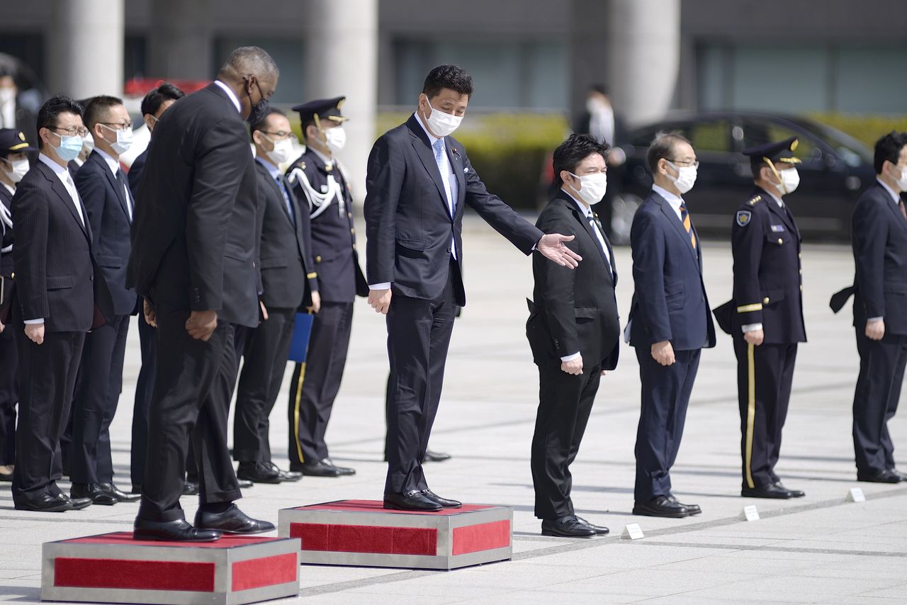 Lloyd Austin, Secretary of Defense of the United States of America (L) and Japanese Defense Minister Kishi Nobuo (R) attend a review an honor guard prior the US-Japan Defense Ministers Bilateral meeting at the Japan Ministry of Defense on March 16, 2021 in Tokyo, Japan. David Mareuil/Pool via REUTERS