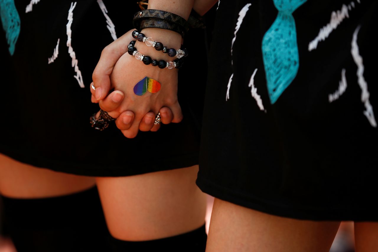 FILE PHOTO: Women hold hands during the Tokyo Rainbow Pride parade celebrating lesbian, gay, bisexual, and transgender (LGBT) culture in Tokyo, Japan, May 8, 2016. REUTERS/Thomas Peter