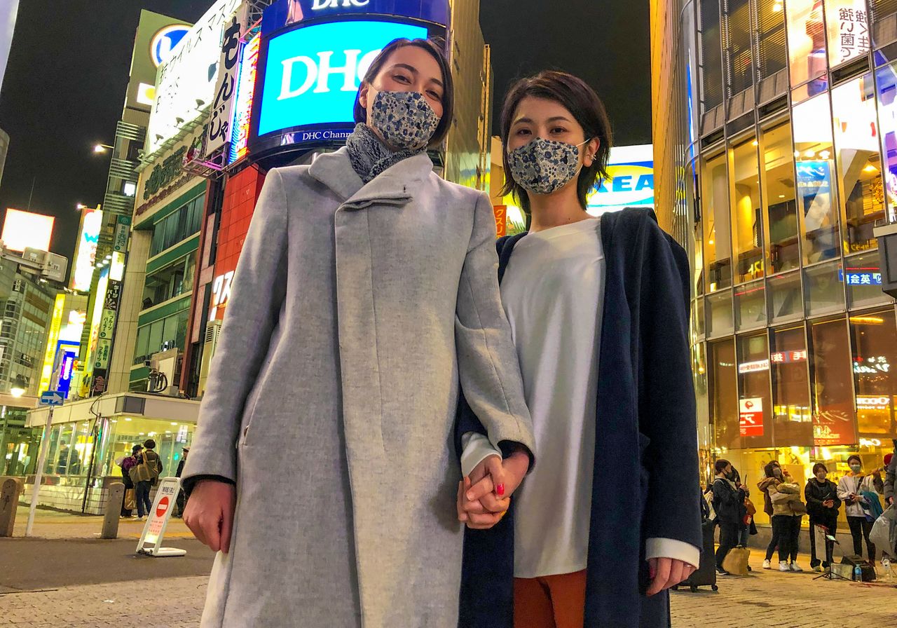 Lesbian couple Jenny and Narumi pose at Shibuya crossing in Tokyo, Japan, March 19, 2021. Picture taken March 19, 2021. REUTERS/Akira Tomoshige