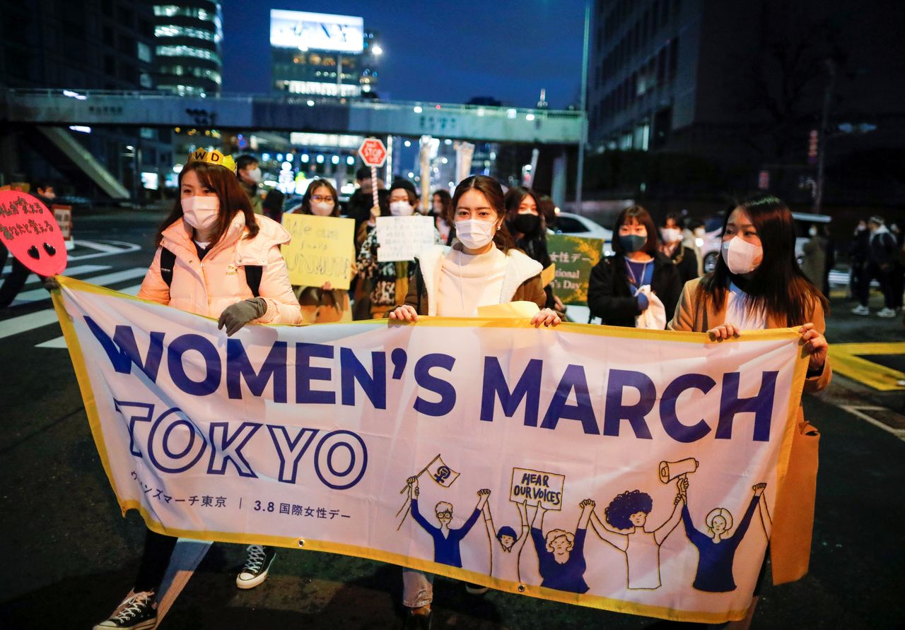 Demonstrators hold a banner as they take part in a march to call for gender equality and protest against gender discrimination, marking the International Women's Day in Tokyo, Japan March 8, 2021. REUTERS/Issei Kato