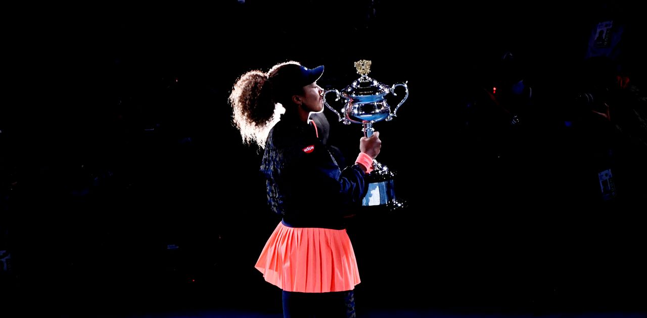 FILE PHOTO: Tennis - Australian Open - Women's Singles Final - Melbourne Park, Melbourne, Australia, February 20, 2021 Japan's Naomi Osaka celebrates kisses the trophy as she celebrates after winning her final match against Jennifer Brady of the U.S. REUTERS/Jaimi Joy/File Photo