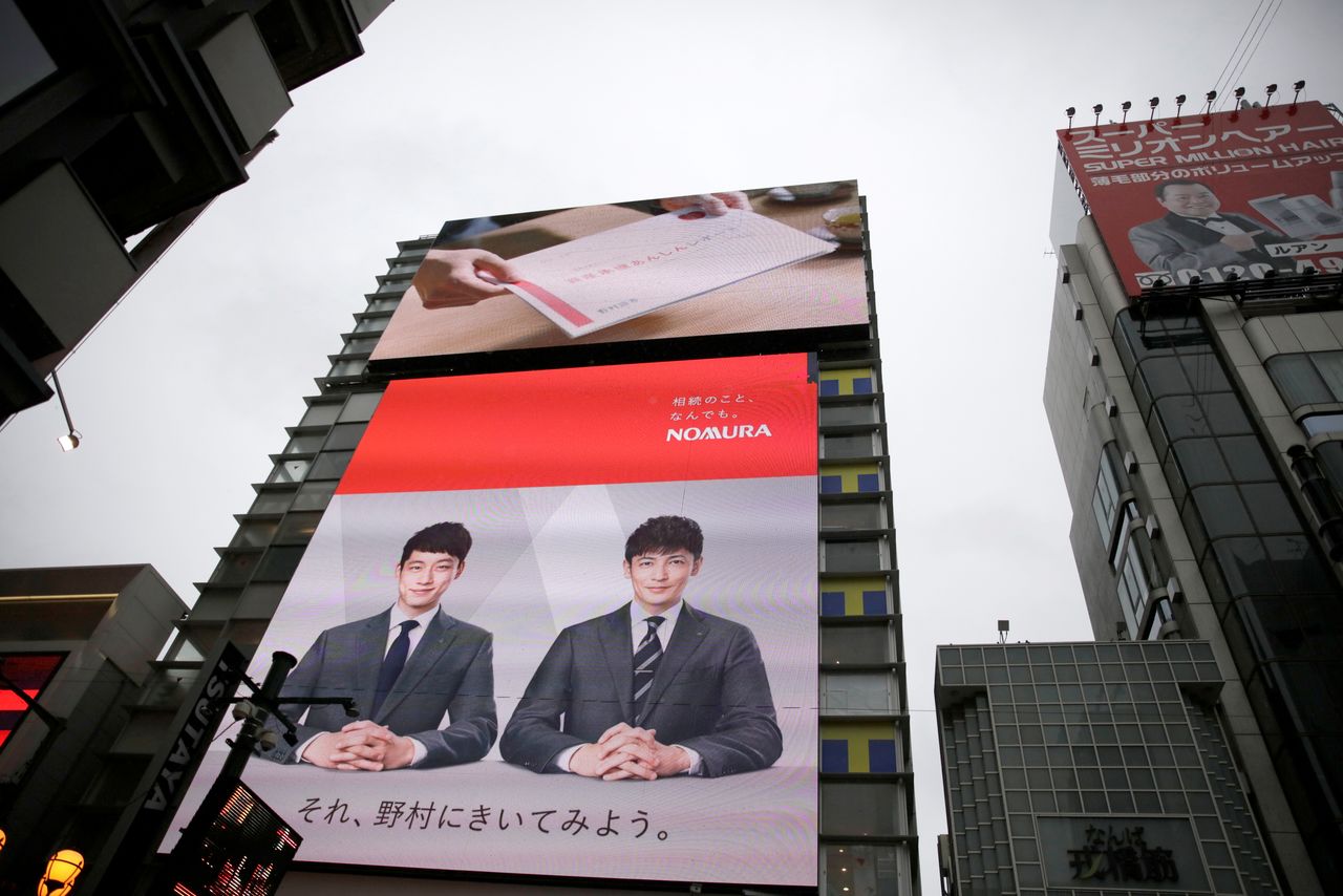FILE PHOTO: A Nomura commercial is shown on a television screen in Osaka, western Japan October 22, 2017. Picture taken October 22, 2017. REUTERS/Thomas White