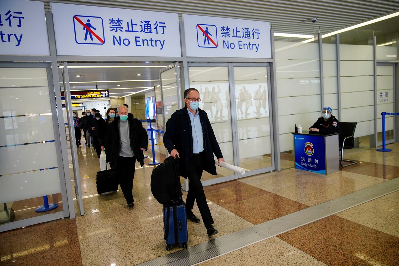 FILE PHOTO: Peter Ben Embarek, and other members of the World Health Organisation (WHO) team tasked with investigating the origins of the coronavirus disease (COVID-19), arrive at the Pudong International Airport in Shanghai, China February 10, 2021. REUTERS/Aly Song/File Photo