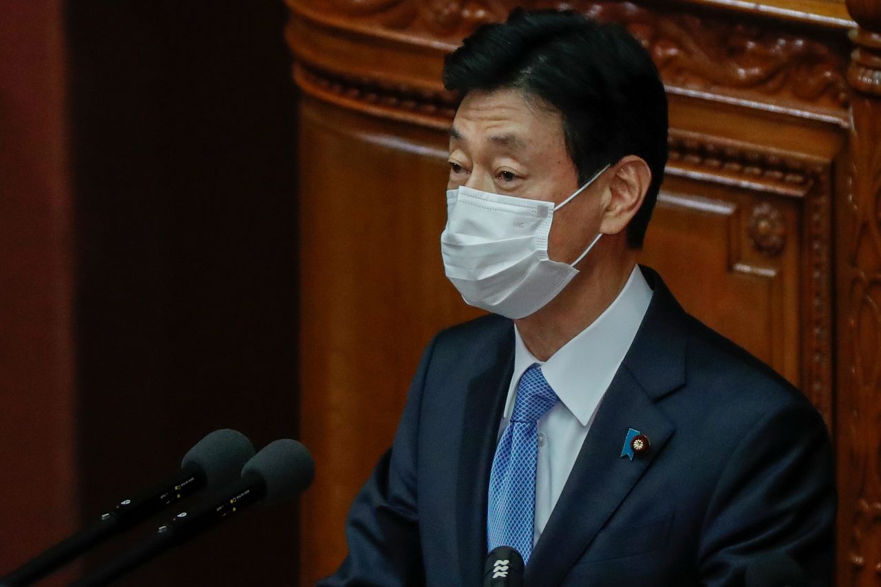 FILE PHOTO: Japan's Economy Minister and minister in charge of coronavirus response Yasutoshi Nishimura delivers his policy speech at the opening of the Lower House plenary session in Tokyo, Japan January 18, 2021. REUTERS/Issei Kato