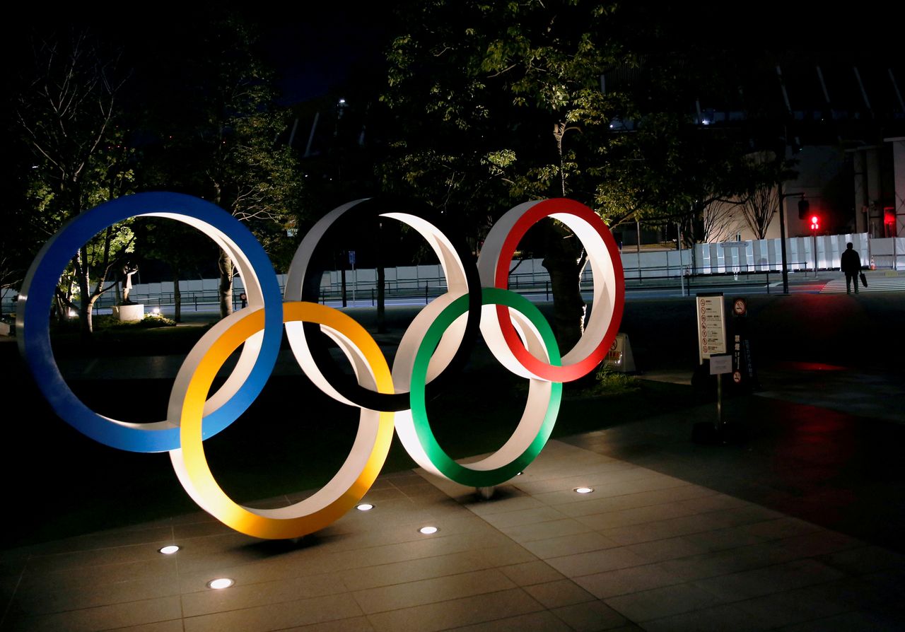 FILE PHOTO: The Olympic rings are illuminated in front of the National Stadium in Tokyo, Japan January 22, 2021. REUTERS/Kim Kyung-Hoon