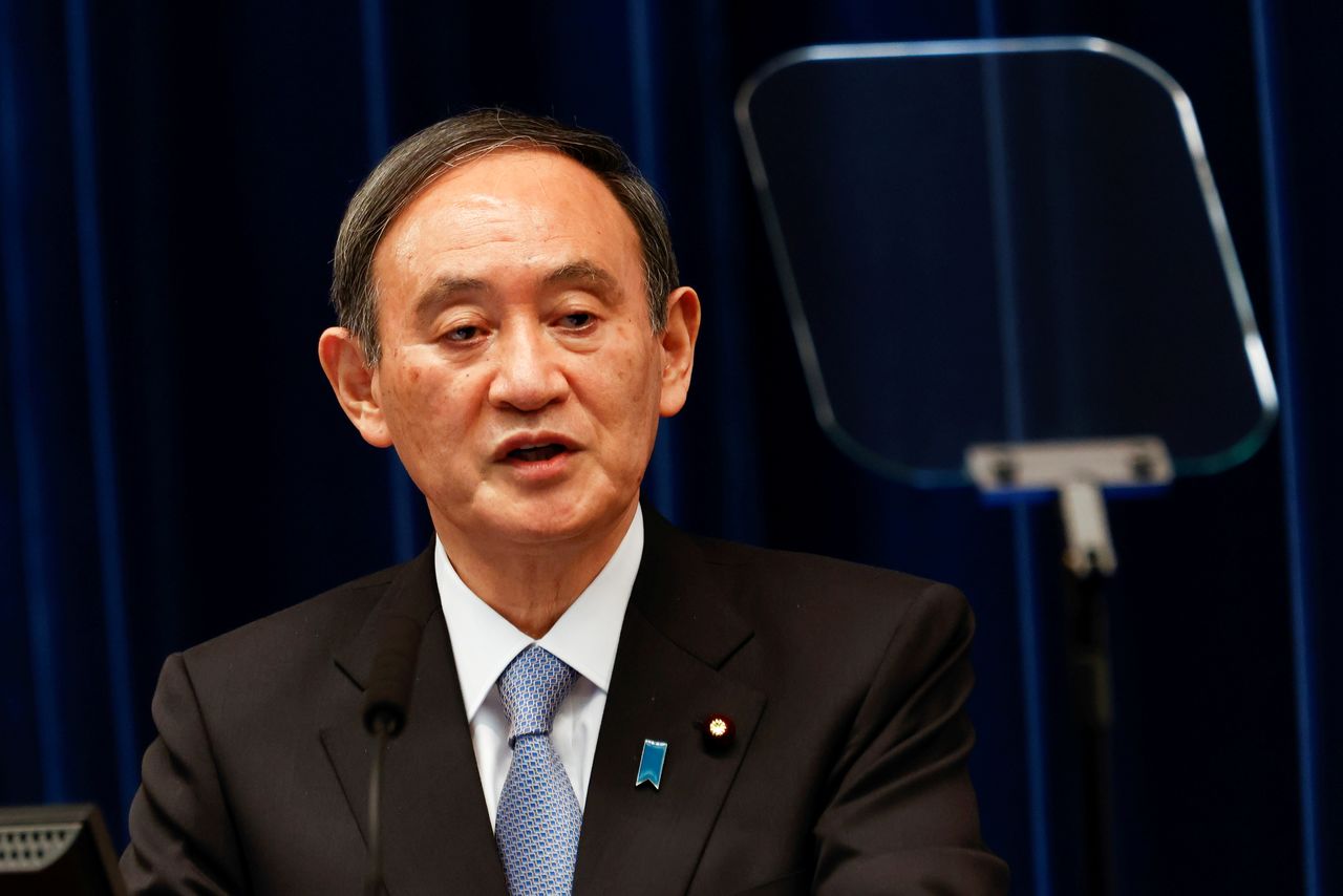 FILE PHOTO: Japan's prime minister, Yoshihide Suga, speaks during a press conference at the prime minister's official residence in Tokyo, Japan March 18, 2021. Rodrigo Reyes Marin/Pool via REUTERS