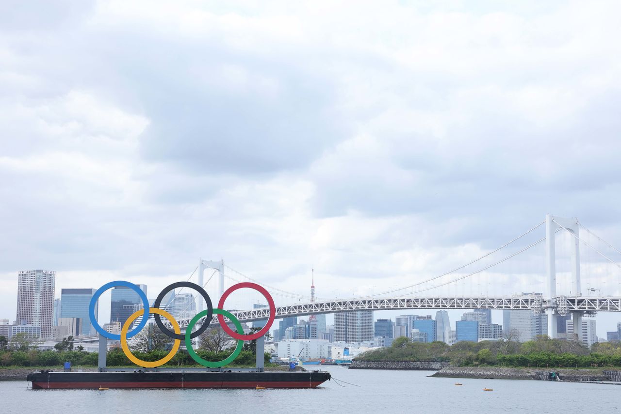 Apr 6, 2021; Tokyo, JAPAN; General view of the Olympic rings sculpture, Rainbow Bridge, and Tokyo Tower as seen from Odaiba in preparation for the Tokyo 2020 Olympic Summer Games set to begin in July 2021. Mandatory Credit: Yukihito Taguchi-USA TODAY Sports