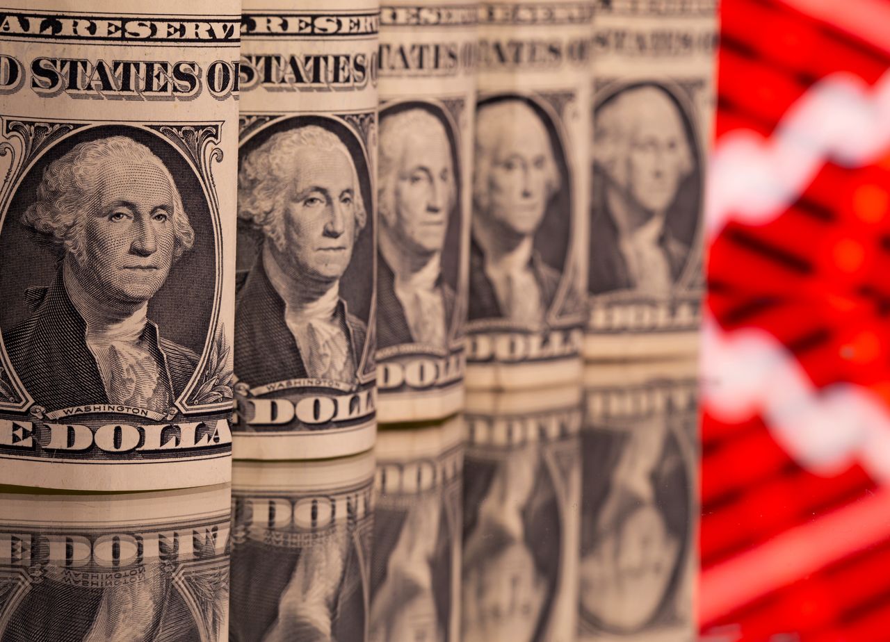 FILE PHOTO: U.S. one dollar banknotes are seen in front of displayed stock graph in this illustration taken February 8, 2021. REUTERS/Dado Ruvic/Illustration/File Photo