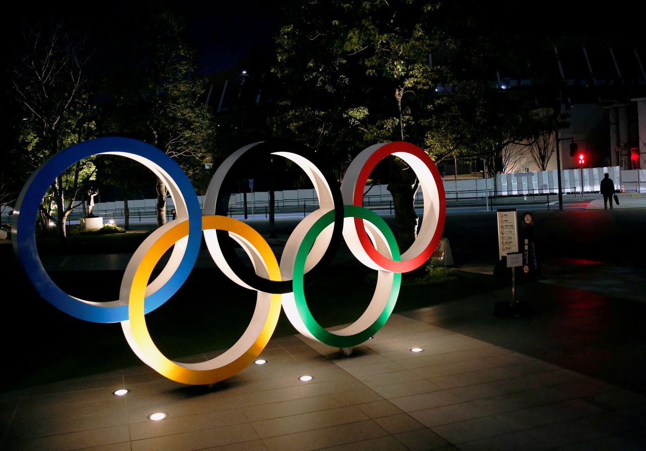 FILE PHOTO: The Olympic rings are illuminated in front of the National Stadium in Tokyo, Japan January 22, 2021. REUTERS/Kim Kyung-Hoon