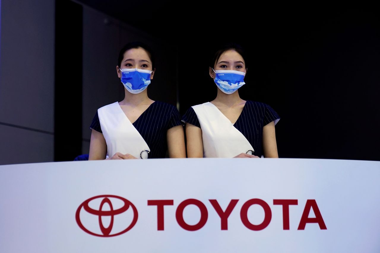FILE PHOTO: Staff members stand at the Toyota booth during a media day for the Auto Shanghai show in Shanghai, China April 19, 2021. REUTERS/Aly Song/File Photo