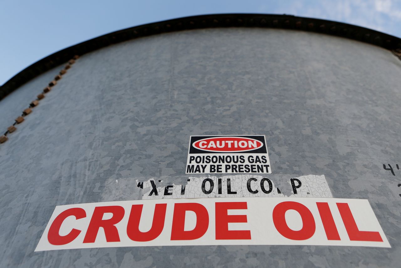 FILE PHOTO: A sticker reads crude oil on the side of a storage tank in the Permian Basin in Mentone, Loving County, Texas, U.S. November 22, 2019. REUTERS/Angus Mordant
