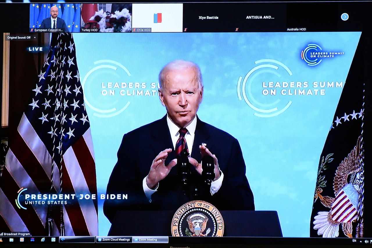 U.S. President Joe Biden is seen on the screen as European Council President Charles Michel attends a virtual U.S. global climate summit, in Brussels, Belgium, April 22, 2021. REUTERS/Johanna Geron/Pool