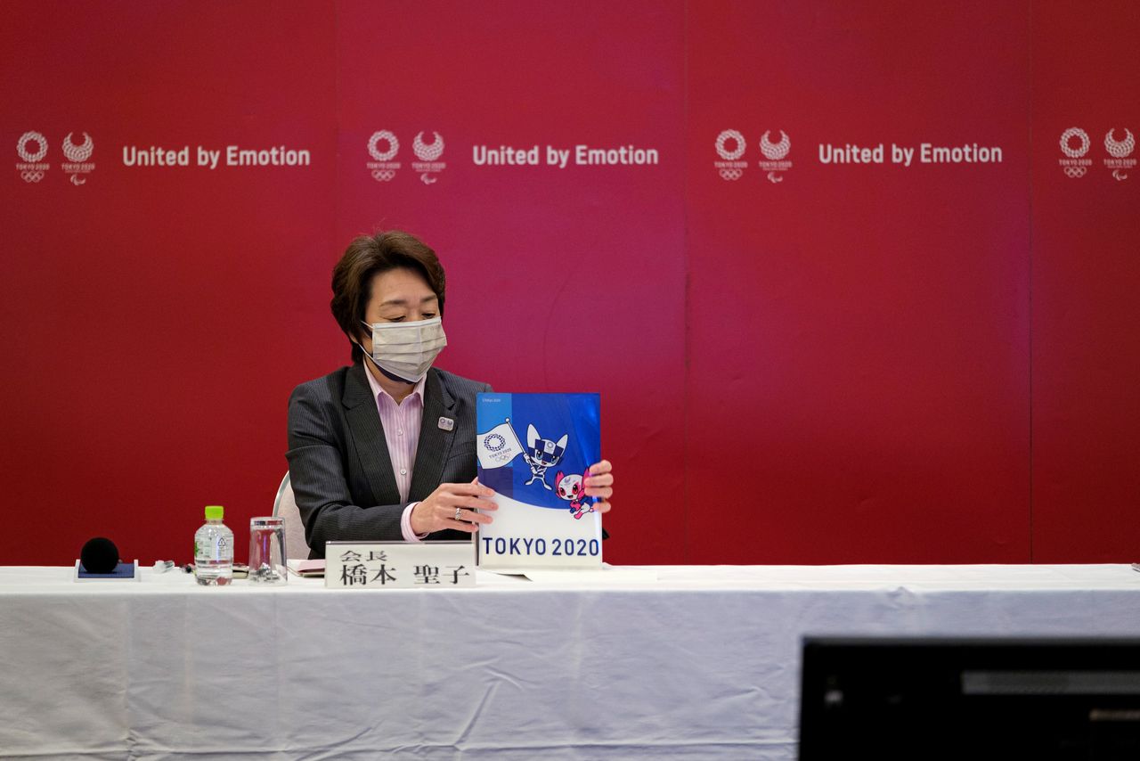 President of the Tokyo 2020 Olympic and Paralympic Games Organizing Committee, Seiko Hashimoto, holds a Tokyo 2020 folder during a Tokyo 2020 executive board meeting in Tokyo, Japan, April 26, 2021. Nicolas Datiche/Pool via Reuters