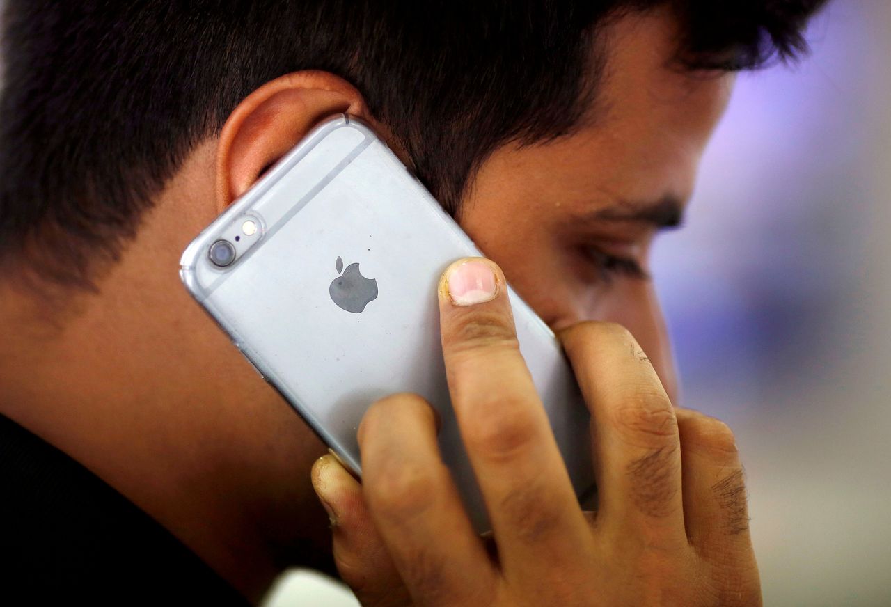 FILE PHOTO: A man talks on his iPhone at a mobile phone store in New Delhi, India, July 27, 2016. REUTERS/Adnan Abidi