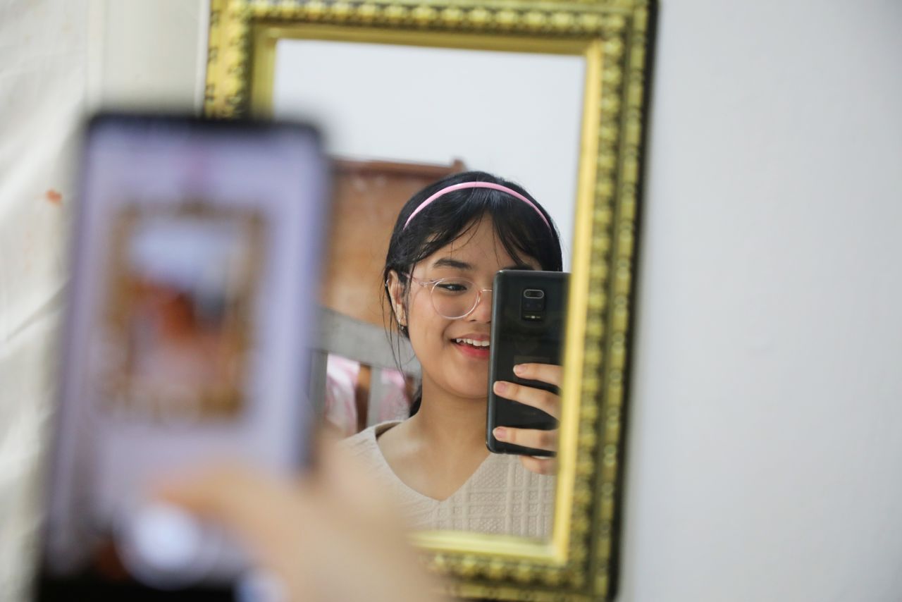 FILE PHOTO: Malaysian teenager Ain Husniza Saiful Nizam takes video for her TikTok page at her bedroom in Kuala Selangor, Malaysia April 29, 2021. REUTERS/Lim Huey Teng