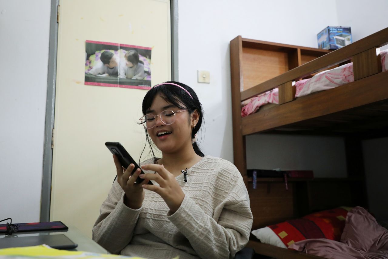 FILE PHOTO: Malaysian teenager Ain Husniza Saiful Nizam uses her phone to check on the comments towards her TikTok video in her bedroom in Kuala Selangor, Malaysia April 29, 2021. REUTERS/Lim Huey Teng