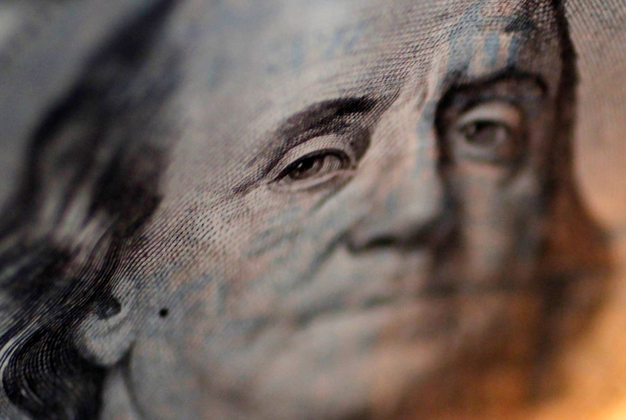 A portrait of Benjamin Franklin on a U.S. One-hundred dollar bill is pictured at Interbank Inc. money exchange in Tokyo, in this September 9, 2010 picture illustration. REUTERS/Yuriko Nakao/File Photo